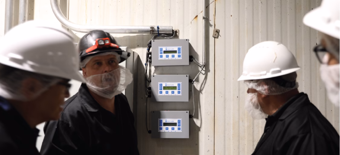 employees checking conveyor monitor